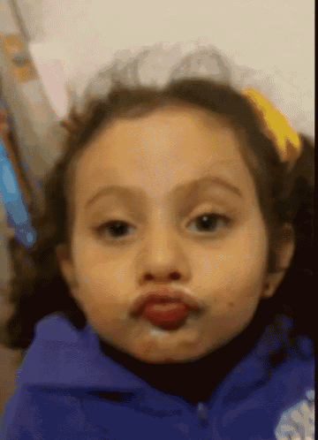 a little girl making a funny face with her mouth covered in milk