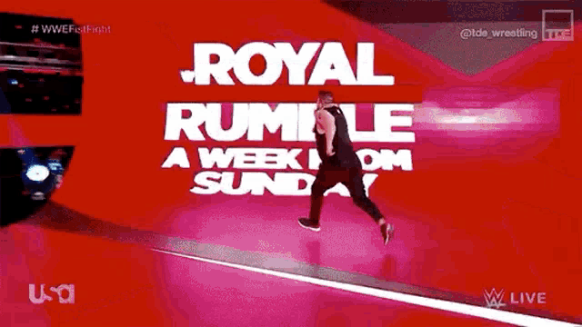 a wrestler is running on a pink mat in front of a red background that says royal rumble a week from sunday .