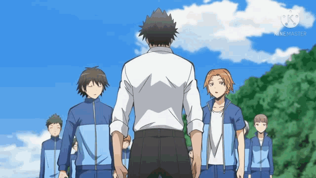 a man in a white shirt stands in front of a group of boys