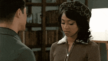 a man and a woman are looking at each other