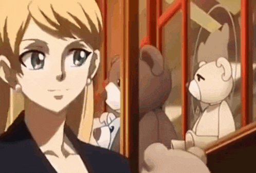 a woman is standing in front of a teddy bear .