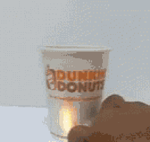 a dunkin donuts cup with a flame coming out of the handle