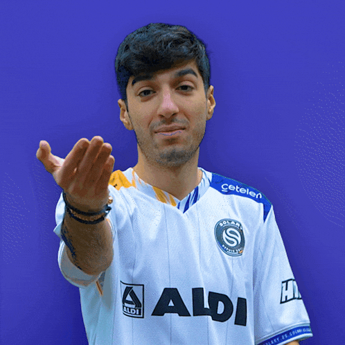 a man wearing a white shirt with the word aldi on the front