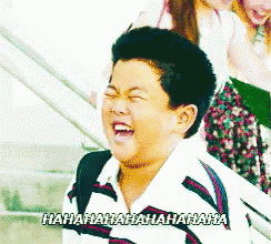 a young boy is laughing with the words ' hahahaha ' on the bottom