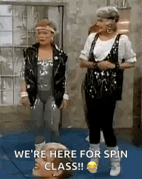 a couple of women are standing next to each other on a mat .