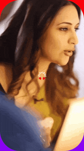 a woman wearing a necklace that says i love on it