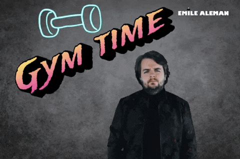 a man is standing in front of a gym time sign