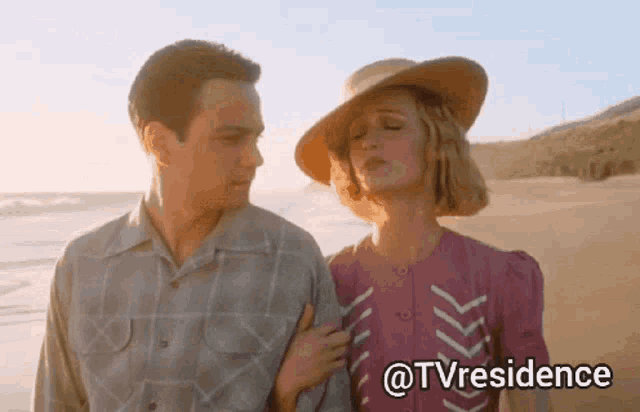 a man and a woman standing on a beach with the hashtag @tvresidence