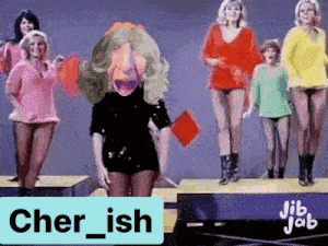 a group of women are dancing on a stage with a sign that says cher ish on it