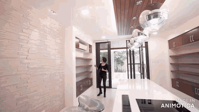 a woman is standing in a kitchen with the words made in animatica on the bottom