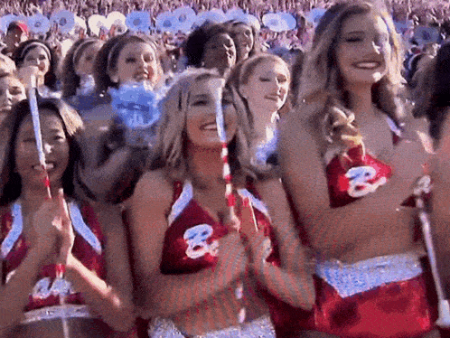 a group of cheerleaders wearing red and white uniforms with the letter b on the front