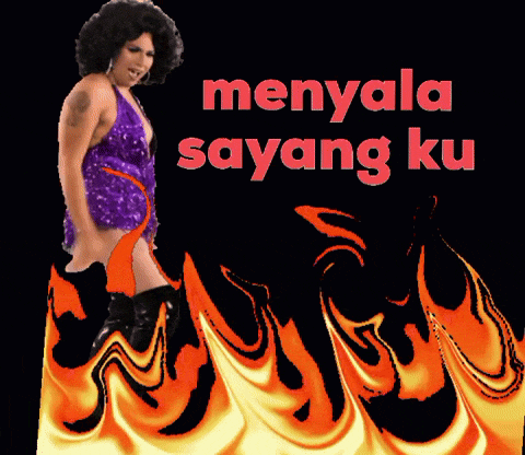 a woman in a purple dress is dancing in front of flames and the words menyala sayang ku in red