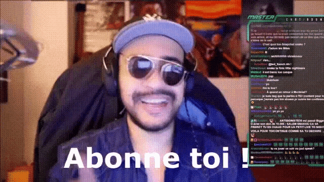 a man wearing sunglasses and a hat says ' abonne toi ' on the screen