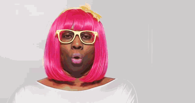 a woman wearing a pink wig and sunglasses
