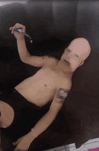 a shirtless man with a tattoo on his arm that says ' i love you ' on it