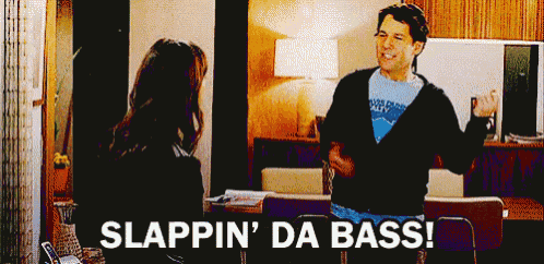 a man is talking to a woman in a living room with the words slappin ' da bass written below him