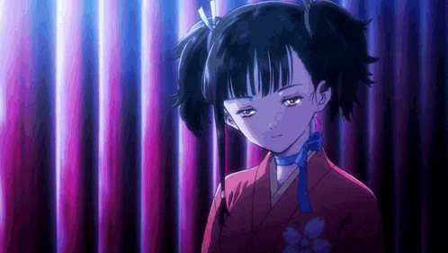a girl with pigtails and a blue scarf around her neck is standing in front of a curtain .