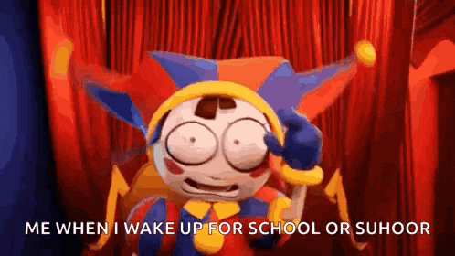 a cartoon jester is sitting on a stage with a red curtain behind him and holding a ball .