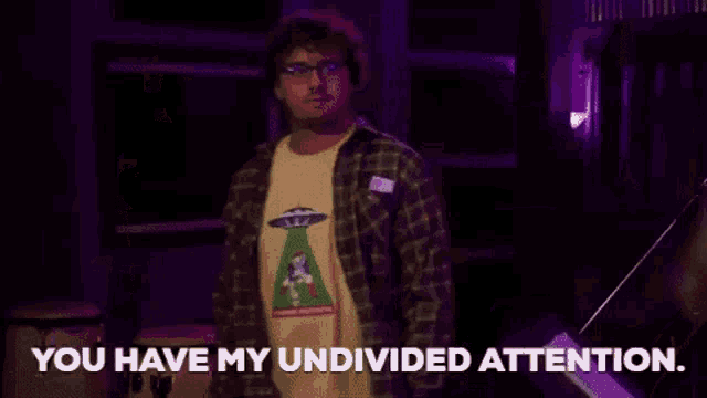 a man wearing glasses and a t-shirt that says `` you have my undivided attention ''