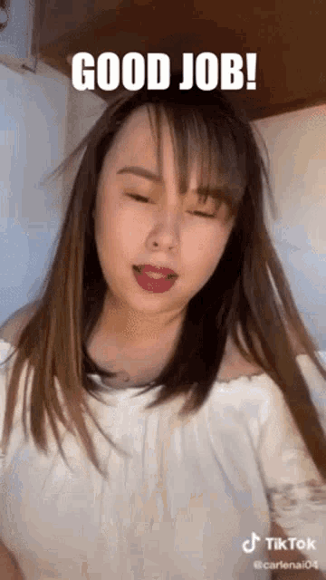 a woman is making a funny face with her eyes closed and the words `` good job '' written on her face .
