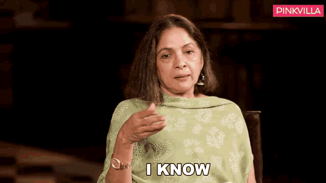 a woman is sitting in a chair and saying i know