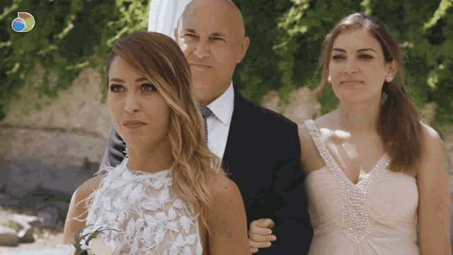 a woman in a white dress is walking down the aisle with her father