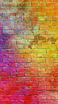 a brick wall with a rainbow of colors painted on it .