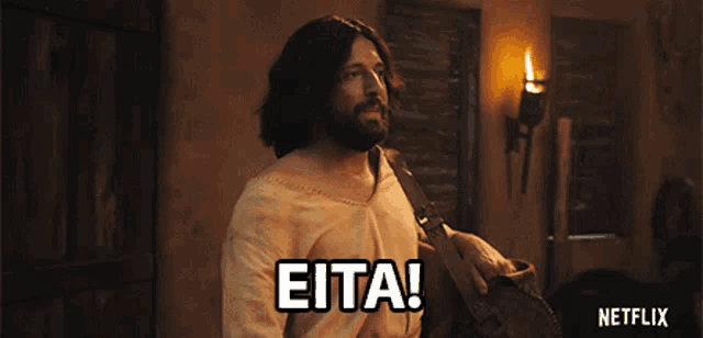 a man in a jesus costume says " eita " in white letters