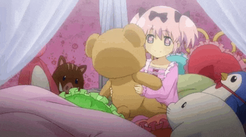 a girl is holding a teddy bear in a bed