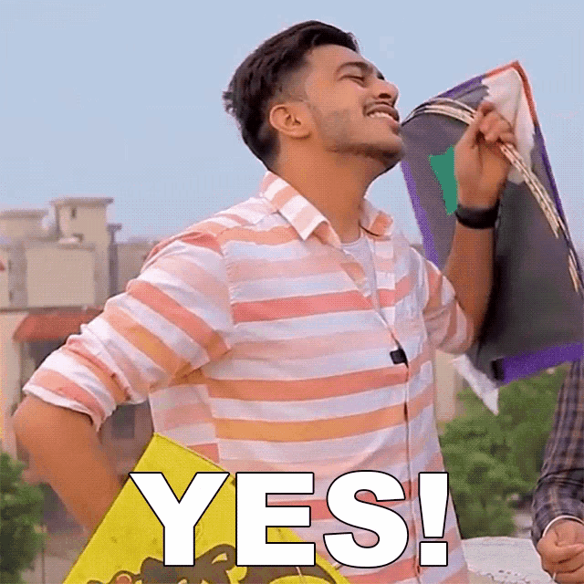 a man in a striped shirt is holding a kite and the word yes is on the bottom right