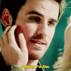 a man with a beard is talking on a cell phone and says nothing . i 'm fine .