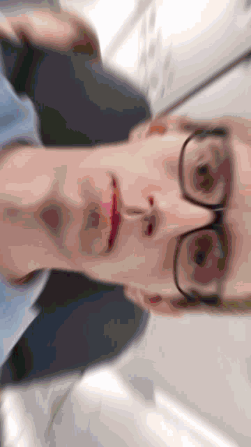 a blurry picture of a man wearing glasses