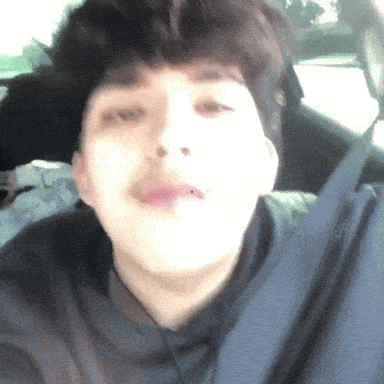 a close up of a person 's face in a car with their mouth open