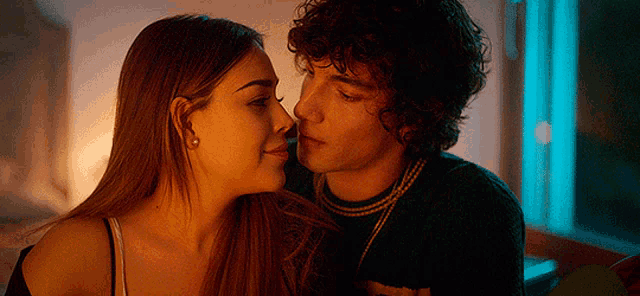 a man and a woman are looking at each other