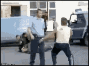 a blurry picture of a man being arrested by a police officer ..