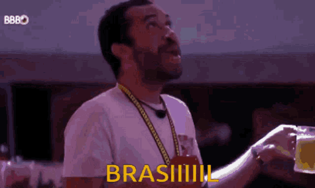 a man in a white shirt is holding a glass of beer and the word brasil is on the bottom
