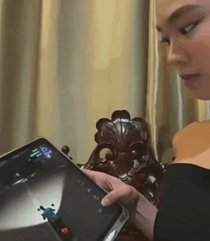 a woman is playing a video game on her phone