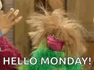 a stuffed animal is waving at a woman and saying `` hello monday '' .