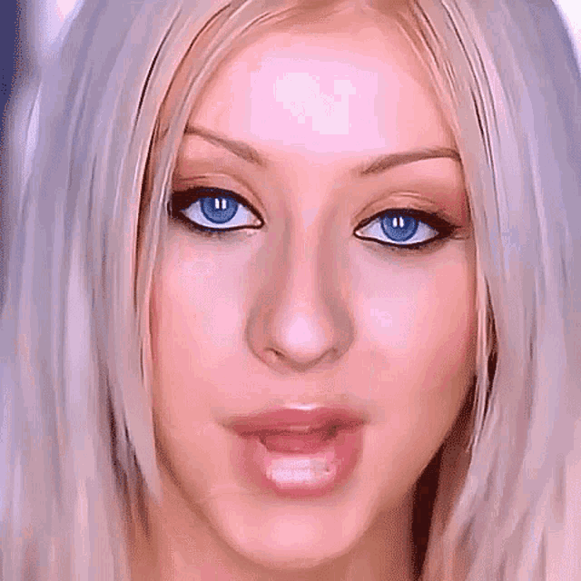 a close up of a woman 's face with her mouth open