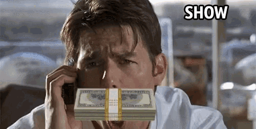 a man talking on a cell phone with a stack of money in front of his face with the word show below him