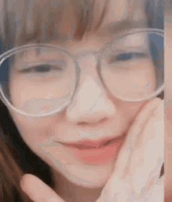 a close up of a woman wearing glasses making a funny face .