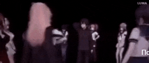 a man with blonde hair is standing in a crowd of people