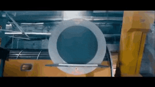 a large circular object is sitting on top of a yellow object .