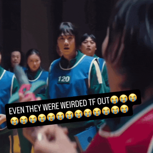 a group of people are standing in a room and one of them has the number 120 on their shirt