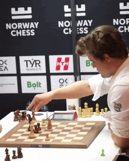 a man is playing chess in front of a sign that says " norway chess "