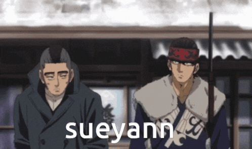 two men are standing next to each other and the word sueyann is on the bottom right