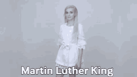 a woman in a white dress is standing in front of a white background with the name martin luther king written on it .