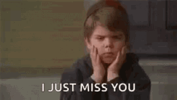 a young boy is sitting on the ground with his hands on his face and the words `` i just miss you '' .