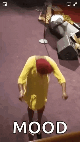 a woman in a yellow dress is dancing in front of a microphone with the word mood above her