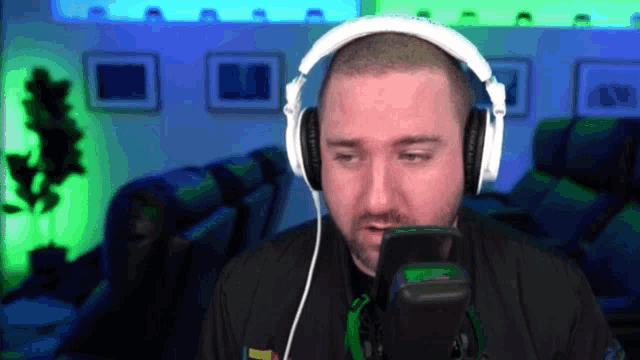 a man wearing headphones is looking at a phone